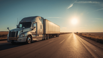 Sleek modern new model heavy duty truck driving on the road in summer heat with bright sun_edited